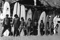 Eight of the nine surfing kids join dad (left)