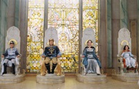 The children, now kings and queens of Narnia, sit on their thrones at Cair Paravel