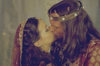 Esther and Xerxes share a kiss in the palace