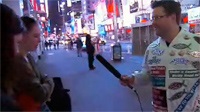 Merchant in his 'bumper sticker suit,' interviewing folks at Times Square