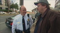 Michael Moore confronted by a secret service officer