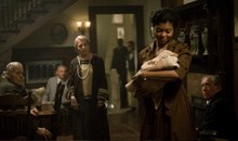 Taraji P. Henson as Queenie, holding the infant Benjamin