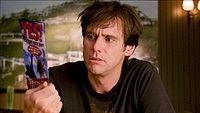 Carl (Jim Carrey) ponders the brochure from the Yes seminar