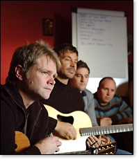 Steven Curtis Chapman, Paul Baloche, and Tim Hughes listen intently to their fellow songwriters at Compassionart