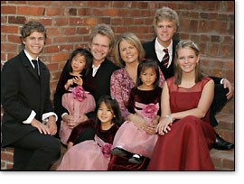 A recent photo of the Chapman family with Steven holding Maria