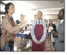 Taylor (left) on the set with Michael W. Smith (in the maroon apron)