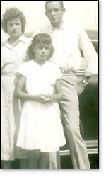 A young Joanne (center) with her older brother Johnny in a family photo.