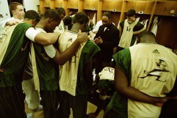 Coach Joyce leads his team in prayer before a game