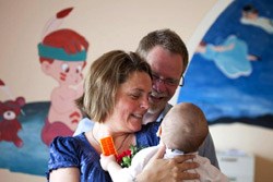 Steven and Mary Beth with a baby at Maria's Big House