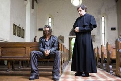 Syracuse meets with the priest (Stephen Rea)