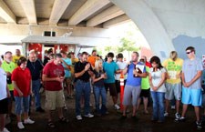 Christmas (3rd from right) and volunteers pray under the bridge