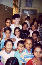 Grant with orphans on a trip to India