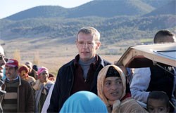 Lambert Wilson as Christian, shown with the locals