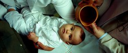 An infant awaits baptism