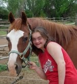 Alex with Gunner, the horse she rides for a therapeutic riding program