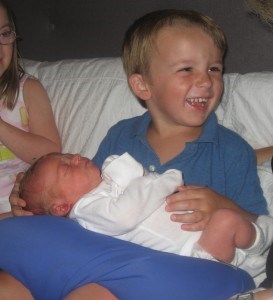 William holds his new baby cousin