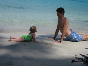 Penny, age 3, learning "upward dog" pose from her dad