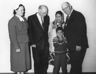 Rachel Saint and President Edman stand with Dayuma, her son Ignacio, and R. G. LeTourneau, Texas industrialist who flew Dayuma and Miss Saint to Wheaton from Sulfur Springs, Arkansas.