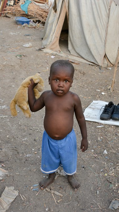 A toddler wanders inside the overcrowded UN camp for civilians in Malakal.