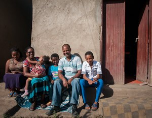 Abraham (middle in the blue shirt) and his family in front of their home in Adama, Ethiopia.