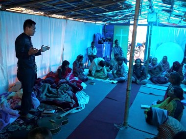 Pastor prays at Thapathali congregation.