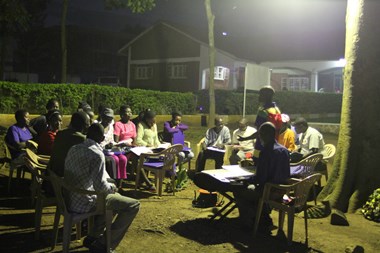 A group of Ugandan churchgoers practice their choir songs on the park-like grounds of the Catholic Martyrs' Shrine.