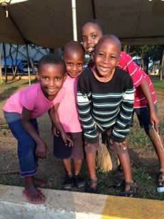  A group of children play and pose for a photograph at the Catholic Martyrs' Shrine.