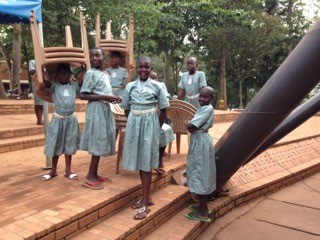 A group of girls bring chairs into the sanctuary at the Catholic Martyrs' Shrine.