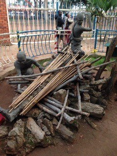 Statues depict workers building a pyre where young men were burned to death at Catholic Martyrs' Shrine. The young men died for their faith in 1886 after resisting the edicts and homosexual advances of King Mwanga. 