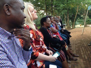 Journalists visiting from Nigeria, Uganda, Kenya, Tanzania, and the United States listen to a tour guide describing the history at the Catholic Martyrs' Shrine.