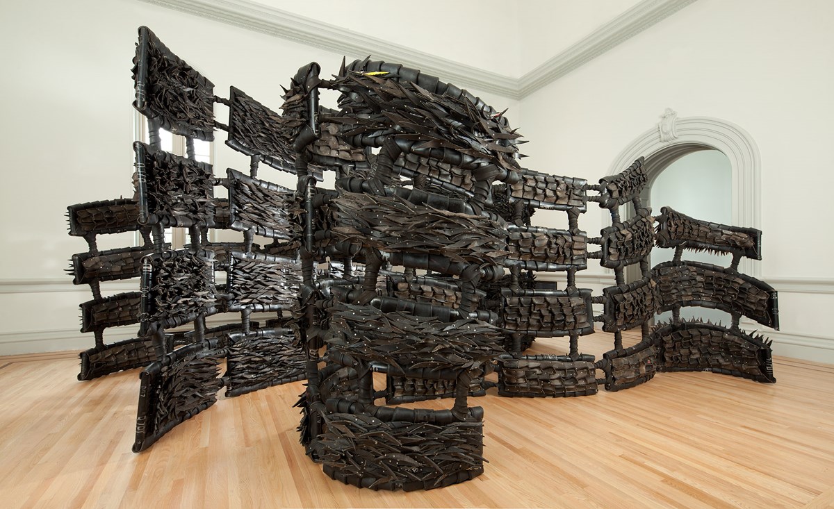 Chakaia Booker’s “Anonymous Donor” invites the visitor to walk through ten-foot walls made from old tires, cut, shredded, folded, and reworked.