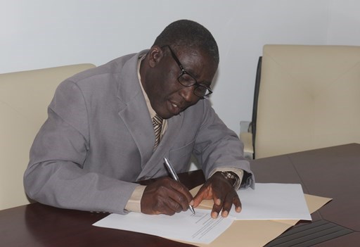 The Christian Association of Nigeria's general secretary, Musa Asake, signs the new declaration.