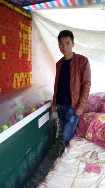 Ding's son stands next to where her body is being stored. Ding's son stands next to where her body is being stored.