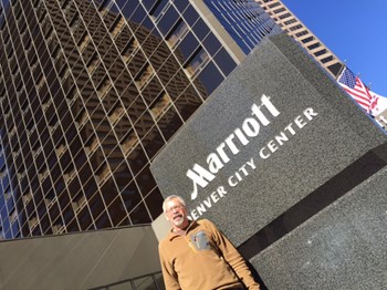 Dave Collins standing in front of the Marriott hotel in Denver where he serves as a housekeeper