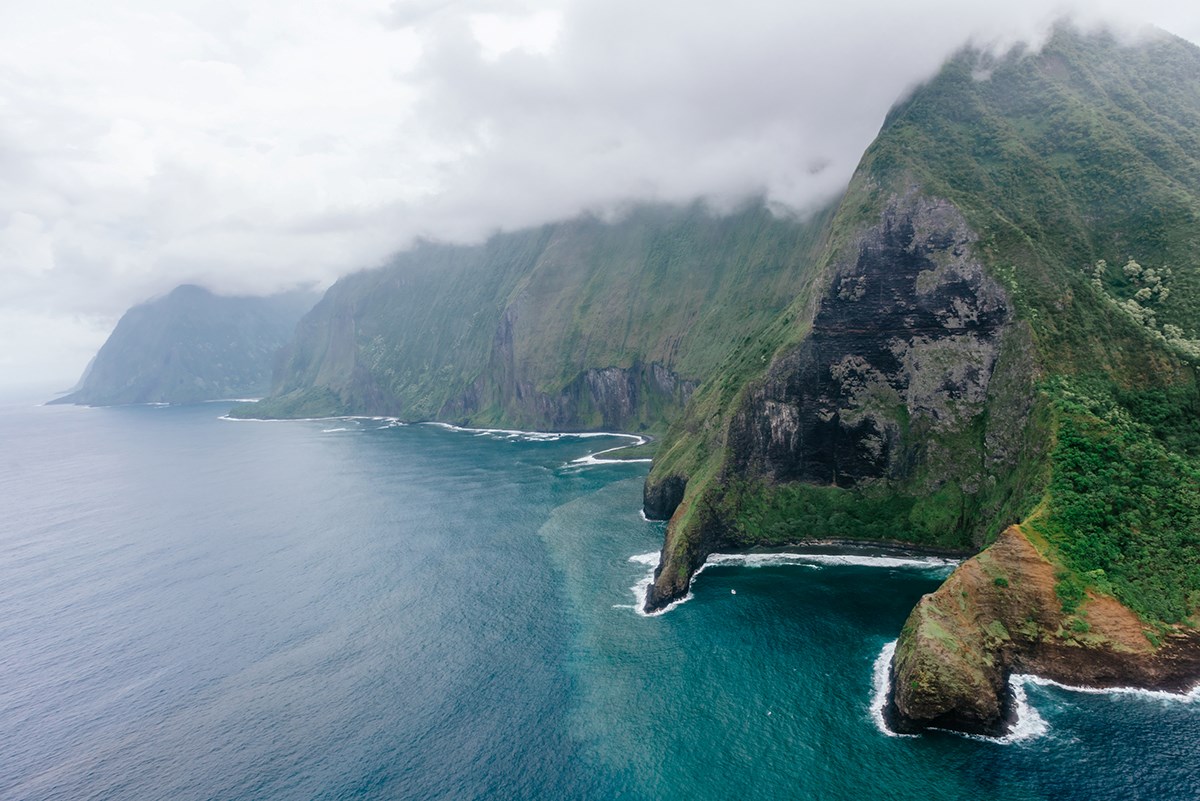 Fog envelops the coastal mountains of Hawaii’s Moloka‘i.
