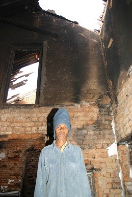 John Pradhan's home in Gurkapia village was ruled to be only "partially damaged." John Pradhan's home in Gurkapia village was ruled to be only "partially damaged."