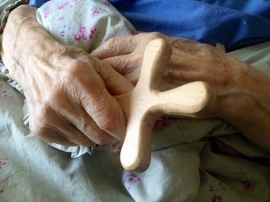 Roald Kverndal holds his new, hand-carved cross. Roald Kverndal holds his new, hand-carved cross.