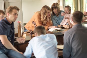 The Voskamp family eats three meals together, after which they read from the Bibles stored in drawers in a specially made dinner table.