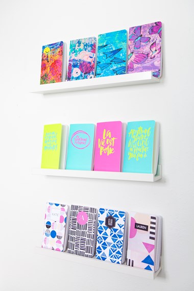 May Designs journals on display. The journal designs featuring butterflies and airplanes are part of the Rise Art Collection, which supports early intervention and inclusive education for children with special needs. 