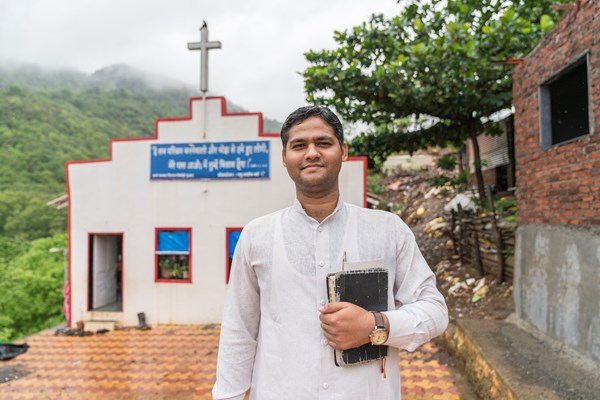 A pastor in front of the church he revived in a Mumbai slum.