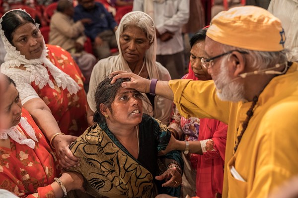 Pastor R. B. Lal prays for deliverance at a Yeshu Darbar service. Pastor R. B. Lal prays for deliverance at a Yeshu Darbar service.