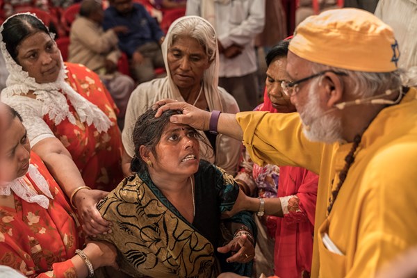 Pastor R. B. Lal prays for deliverance at a Yeshu Darbar service.