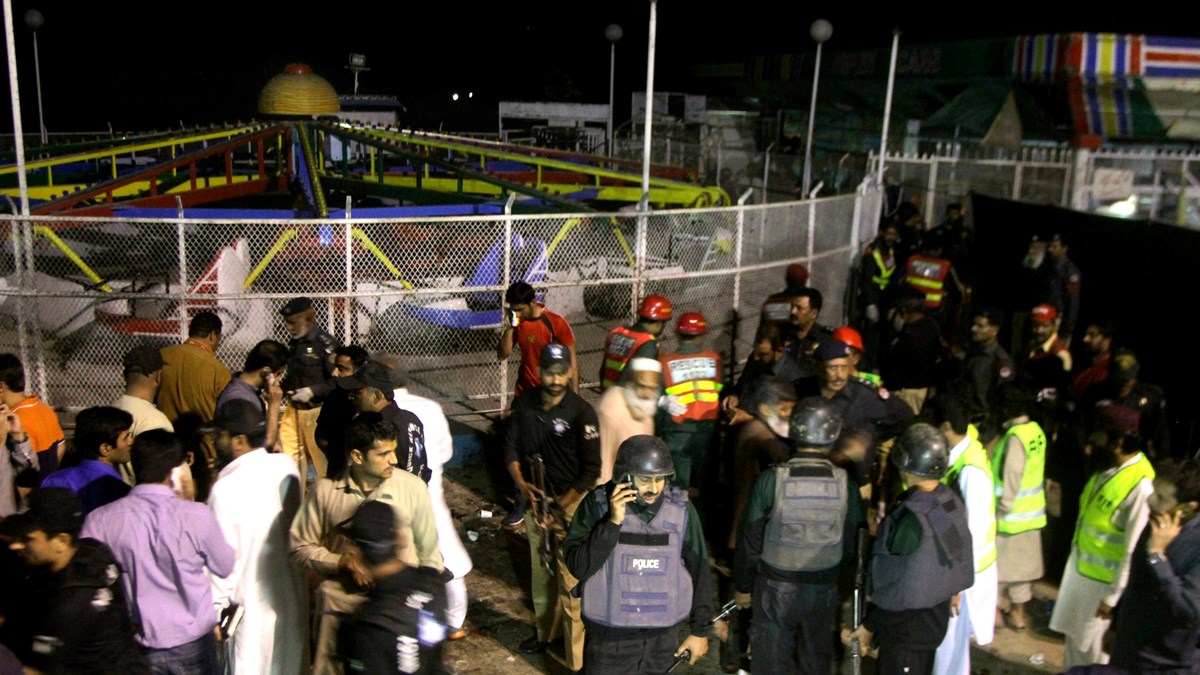 Pakistani police and rescue workers gather at the scene of the attack. Pakistani police and rescue workers gather at the scene of the attack.