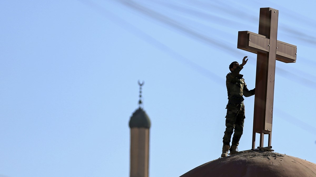 A cross is set on a church damaged by ISIS near Mosul, Iraq. A cross is set on a church damaged by ISIS near Mosul, Iraq.