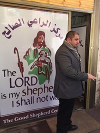 Pastor Haythem in front of the school his church operates for refugees