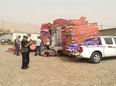 Displaced Iraqi Christians receive mattresses and blankets.