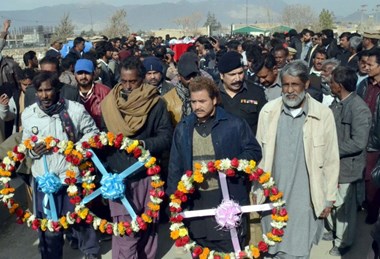 Mourners carry wreaths at the funeral of victims of the Bethel Memorial Church bombing, Quetta, Pakistan.