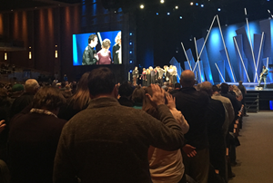 Members and elders pray for the Hybels family.