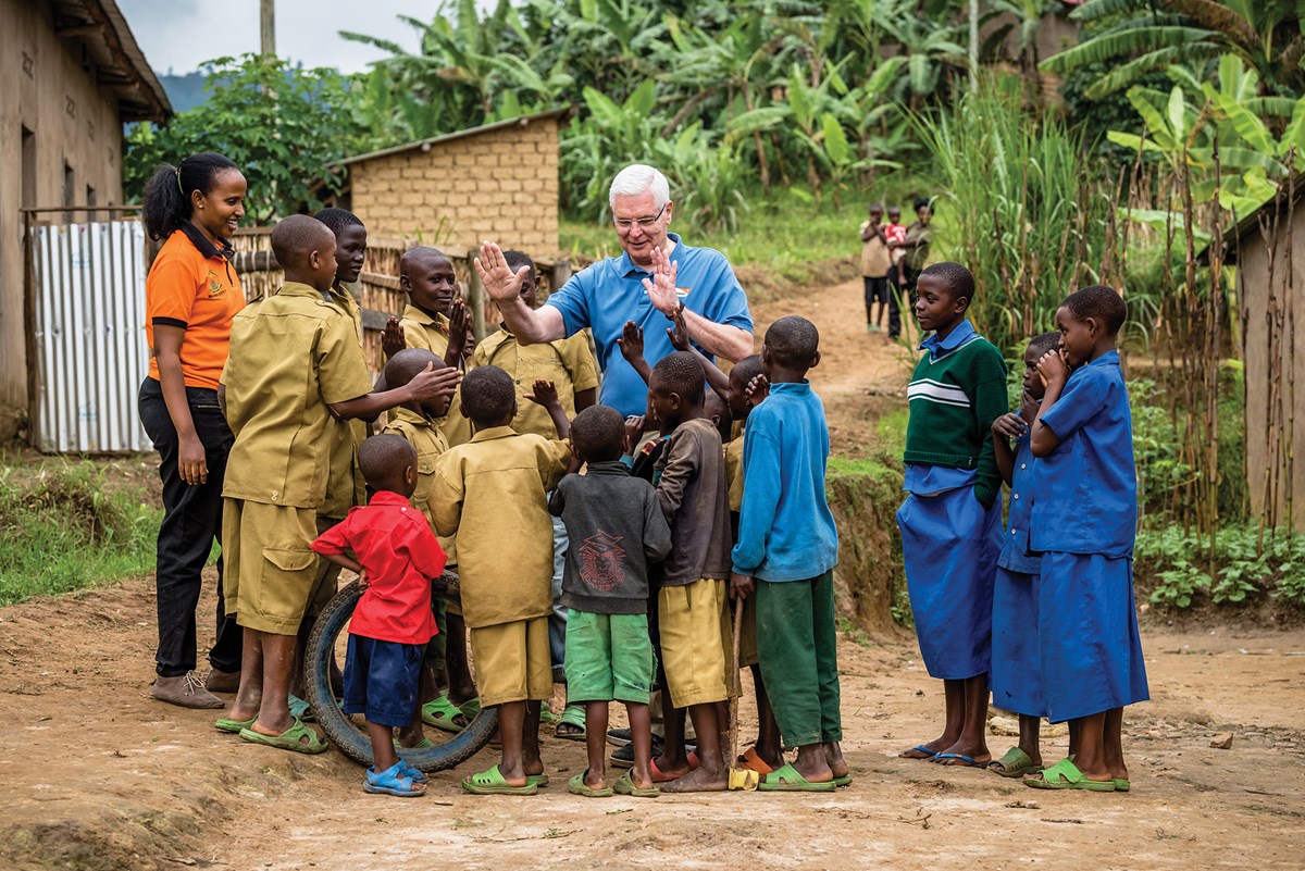 On his last field visit before retirement, Stearns meets sponsored children in Nyarutovu in northern Rwanda, where World Vision has launched an ambitious plan to bring universal access to clean water within five years.