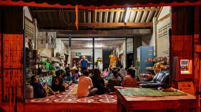 Researcher Dwight Martin (top) shares his testimony with new believers in a Thai house church that gathers in a local storefront.